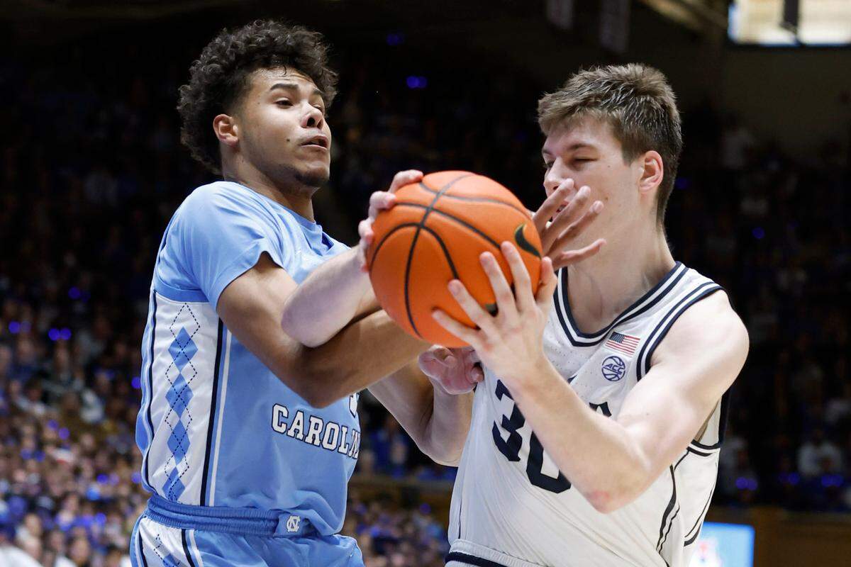 Duke’s Kyle Filipowski (30) drives past North Carolina’s Puff Johnson (14) during the second half of Duke’s 63-57 victory over UNC at Cameron Indoor Stadium in Durham, N.C., Saturday, Feb. 4, 2023.