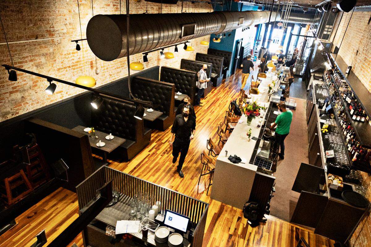 Overlooking staff training in the main dining room at Young Hearts Distilling Company in downtown Raleigh on Wednesday, Aug. 12, 2021, in advance of its official open. Young Hearts will combine a bar and food program in addition to distilling four spirits to start in the former Busy Bee space.