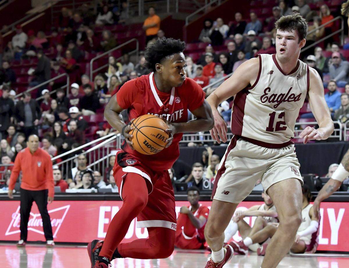 North Carolina State’s Jarkel Joiner (1) dribbles around Boston College’s Quinten Post (12) during the first half of an NCAA college basketball game, Saturday, Feb. 11, 2023, in Boston. (AP Photo/Mark Stockwell)