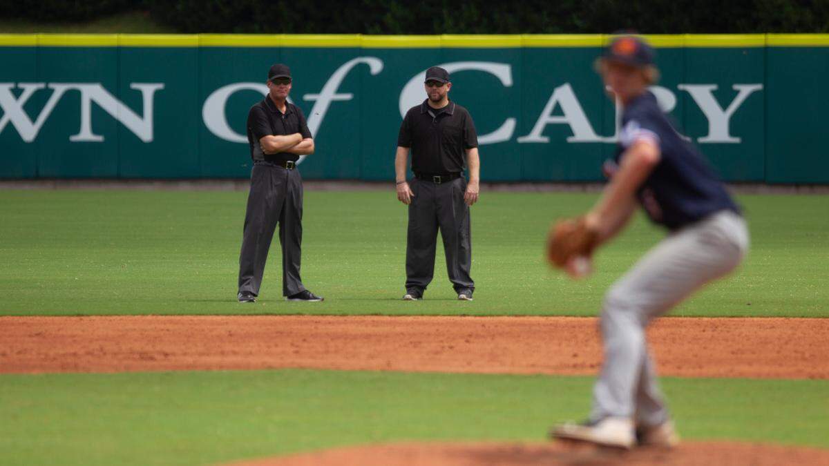 Umpires chat in the outfield between innings during the 17U National Team Championships at the USA Baseball National Training Complex in Cary Thursday, July 30, 2020.