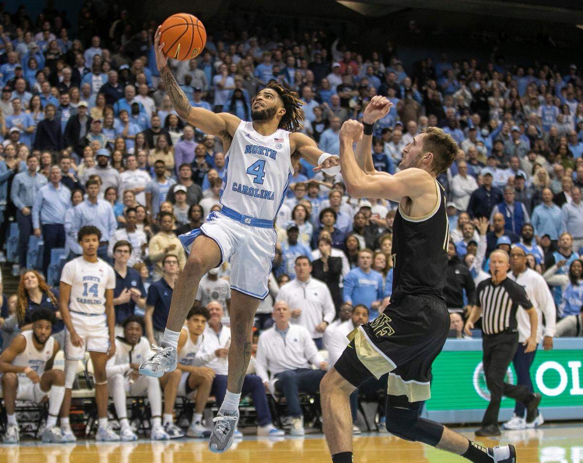 North Carolina’s R.J. Davis (4) drives to the basket against Wake Forest’s Andrew Carr (11) in the second half on Wednesday, January 4, 2023 at the Smith Center in Chapel Hill, N.C. Davis lead North Carolina with 27 points in their 88-79 victory.