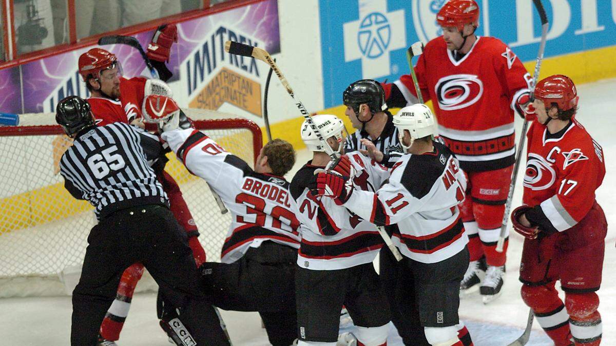 The Canes’ Justin Williams (11), Cory Stillman (61) and Rod Brind’Amour (17) have words with New Jersey’s Martin Brodeur (30), Brian Rafalski (28) and John Madden (11) after Stillman scored a goal during second period action of Game 1 of an NHL playoff game played between the Carolina Hurricanes and the New Jersey Devils at the RBC Center in Raleigh Saturday May 6, 2006.