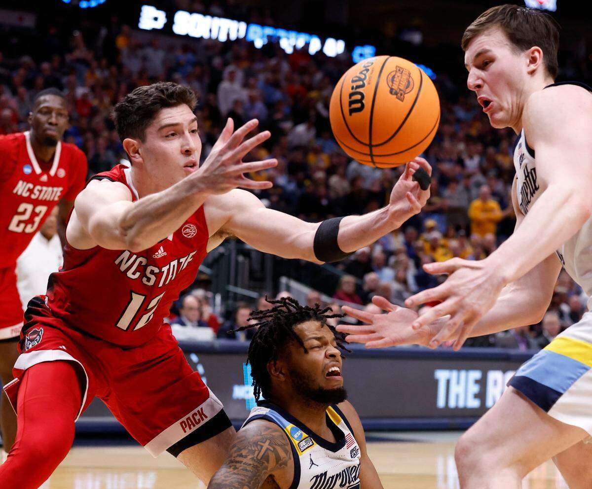 N.C. State’s Michael O’Connell (12) goes after the loose ball with Marquette’s Tyler Kolek (11) during the second half of N.C. State’s 67-58 victory over Marquette in their NCAA Tournament Sweet 16 game at the American Airlines Center in Dallas, Texas, Friday, March 29, 2024.
