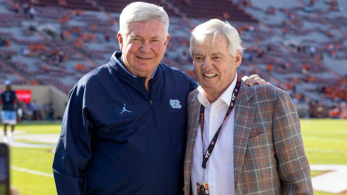 Sally Brown takes a photograph of her husband North Carolina coach Mack Brown with former Virginia Tech coach Frank Beamer prior to the Tar Heels’ game against Virginia Tech on Friday, September 3, 2021 at Lane Stadium in Blacksburg, Va.