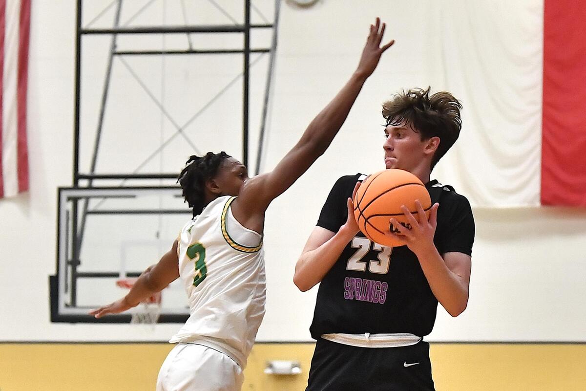 Holly Springs’ Ryan Crotty (23) fakes the shot against Richmond’s JV Drake (3) during the first half. The Richmond Raiders and the Holly Springs Golden Hawks met in the NCHSAA 4A East Regional Finals in Sanford, N.C. on March 4, 2023.