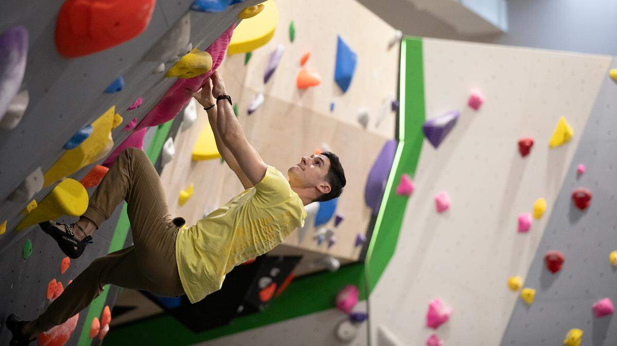 Sage Rosenthal climbs on a bouldering wall at Triangle Rock Club’s new facility in Raleigh’s Salvage Yard on Friday, Sept. 27, 2024.