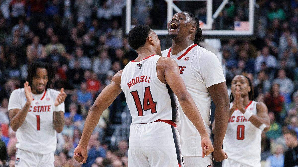 N.C. State’s Casey Morsell and DJ Burns Jr. celebrate in the closing seconds of the Wolfpack’s 79-73 overtime win over Oakland in the second round of the NCAA Tournament on Saturday, March 23, 2024, at PPG Paints Arena in Pittsburgh, Pa.