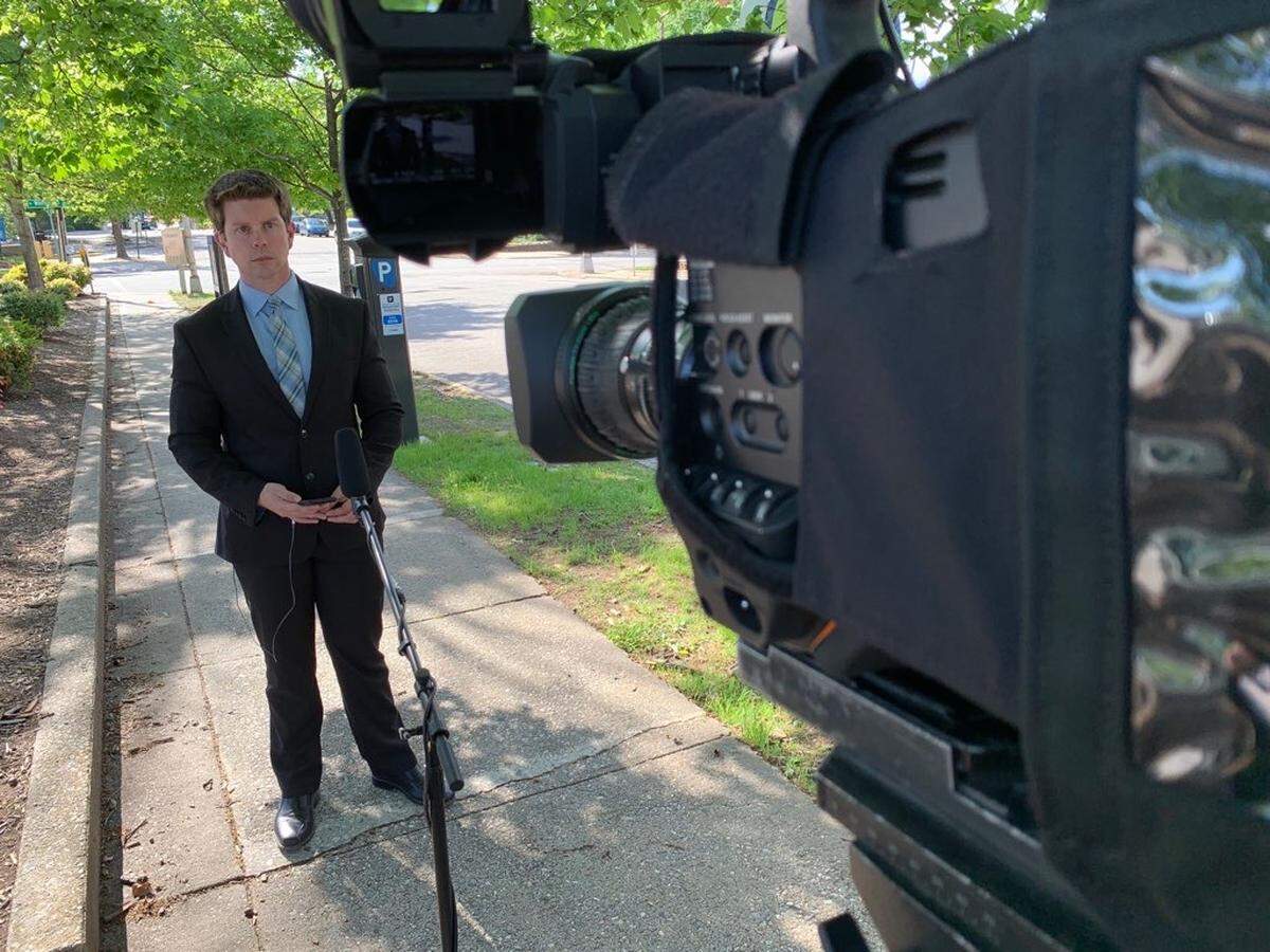 CBS 17 reporter Michael Hyland during a live shot on April 21, 2020. Hyland uses a microphone on a rig, which helps with social distancing during the COVID-19 coronavirus pandemic.