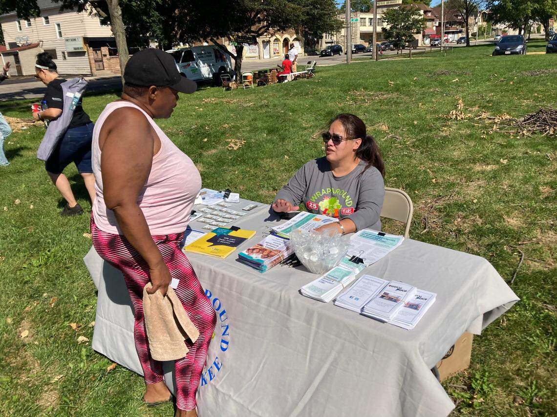 Community activist Felicia Moore speaks with Maria Castillo of Wraparound Milwaukee.