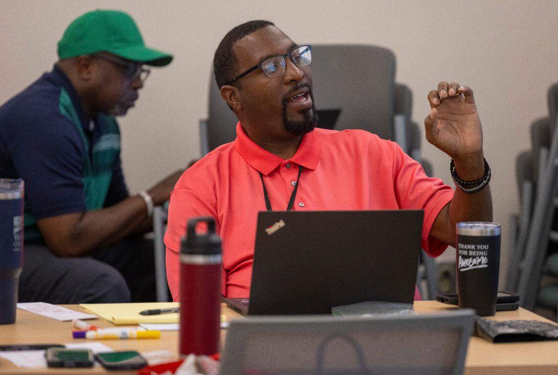 Social Worker William Matthews asks a question during a class on permanency planning at Wake County Health & Human Services in June. Social workers help children who have been abused or neglected find the care they need. But staff shortages have overloaded many.