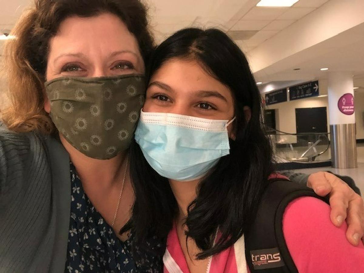 From left to right, Rebecca Olla and her adopted daughter Rina, moments after she landed at the Charlotte Douglas International Airport on Friday, March 4, 2022, after a days-long journey fleeing Ukraine alone through the Hungarian border.