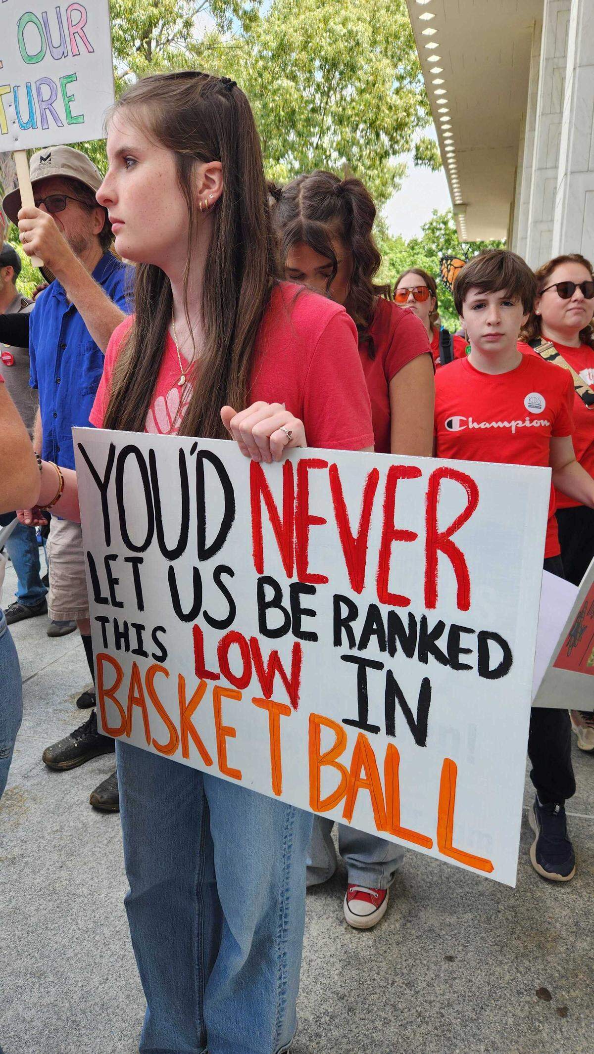Protesters with signs gather around the Legislature in Raleigh.