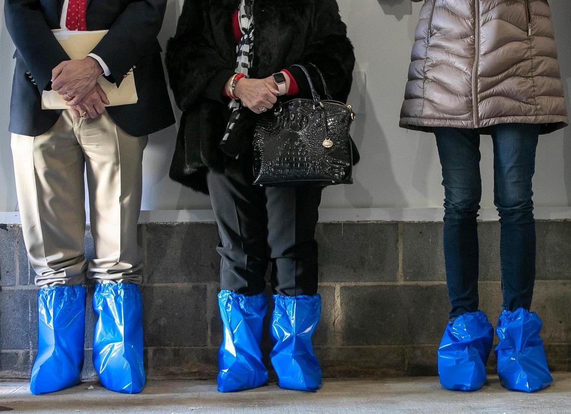 Visitors wear protective shoes coverings during a visit with Chocolate and Chip, the two turkeys that were pardoned by President Joe Biden last week at the White House. The farm on Mid Pines Road hosted a meet and greet with the famous birds on Wednesday, November 23, 202 in Raleigh, N.C.