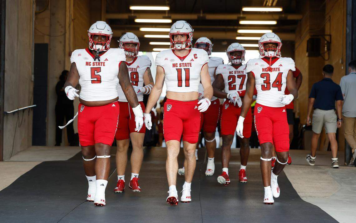 From left N.C. State’s C.J. Clark (5), Payton Wilson (11) and Kamal Bonner (34) head out to the field to warmup before N.C. State’s game against UConn at Rentschler Field in East Hartford, Conn. Thursday, August 31, 2023.