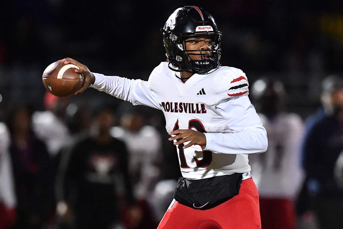 Rolesville quarterback Kaleb Williams looks to pass downfield against Rolesville during the first half. The Apex Friendship Patriots and the Rolesville Rams met in  the second round of the  NCHSAA 8A Playoff game in Apex, N.C. on November 14, 2025. Rolesville wins 14-7 in overtime.