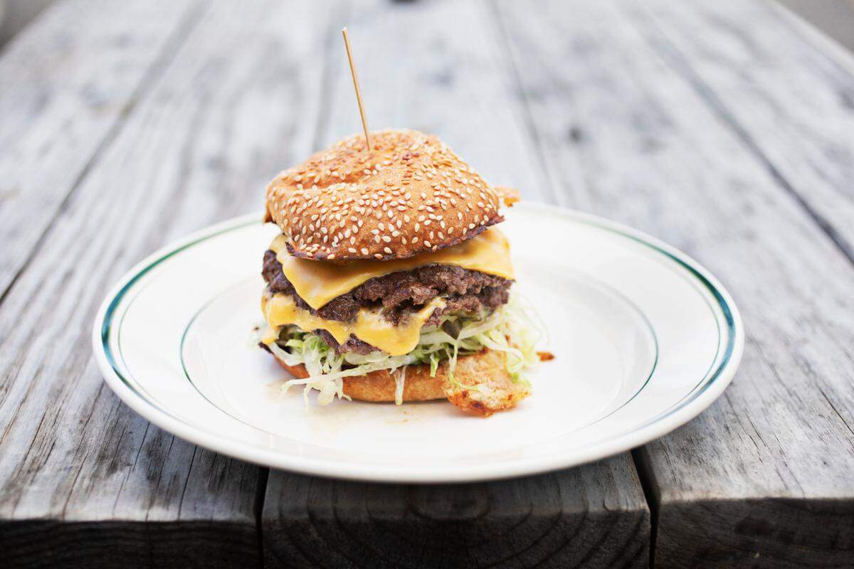 Fine Folk’s Smash Burger in Raleigh is made up of cheese, shredded lettuce, pickle, onion and “fine sauce.”