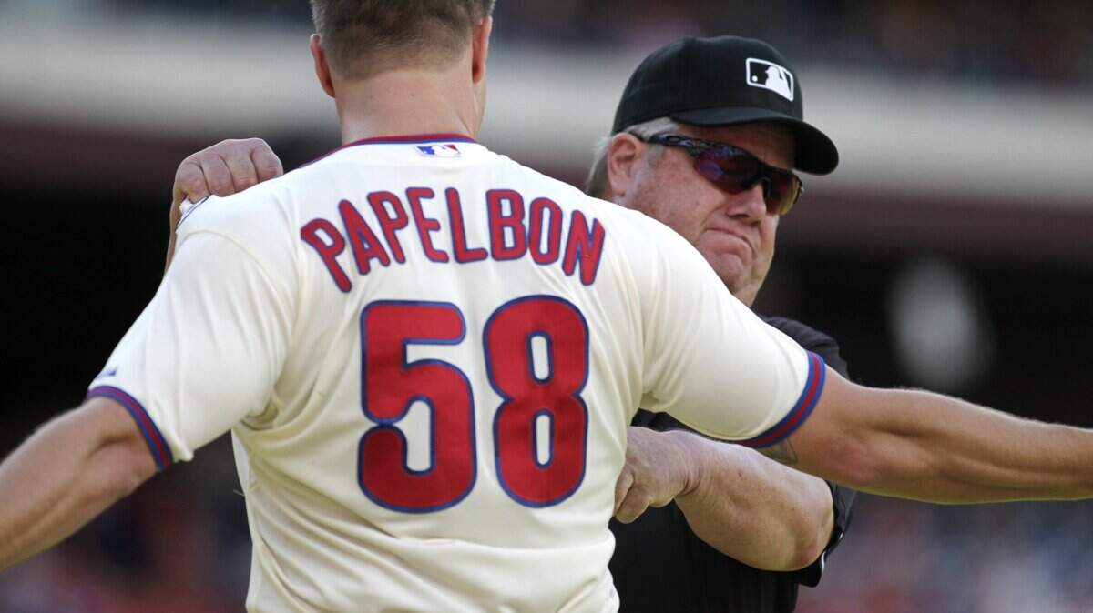 Philadelphia Phillies pitcher Jonathan Papelbon argues with umpire Joe West after being ejected from a game against the Miami Marlins on Sept. 14, 2014. West is being inducted into the North Carolina Sports Hall of Fame on Friday.
