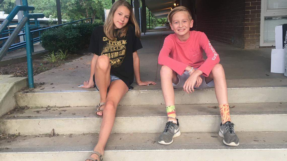 Sixth graders Avery King and Luke Burris visit the now-empty campus of North Ridge Elementary School in Raleigh on June 16 as workers ready the building to be torn down and build a new one in its place.