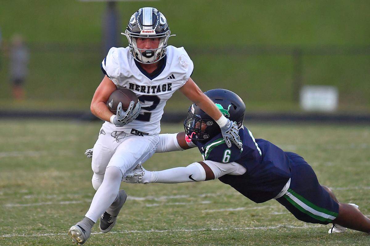 Heritage's Grant Day (2) runs for yardage against Leesville Road's Gavin Lennon (6) during the first half.  The Leesville Road Pride and the Heritage Huskies met in a  football game in Raleigh, N.C. on September 5, 2025.