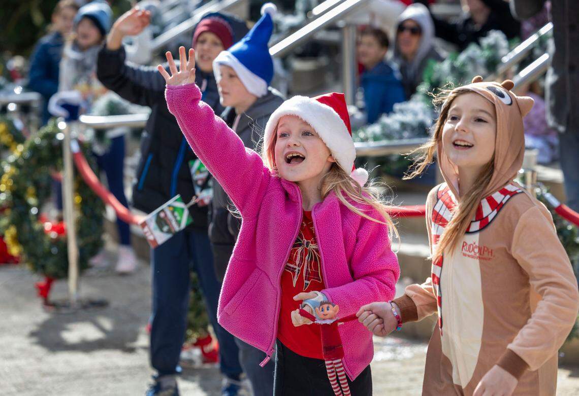Children along Fayetteville Street greet Santa Claus at the conclusion of the 80th annual Raleigh Christmas Parade on Saturday, November 23, 2024 in Raleigh, N.C.