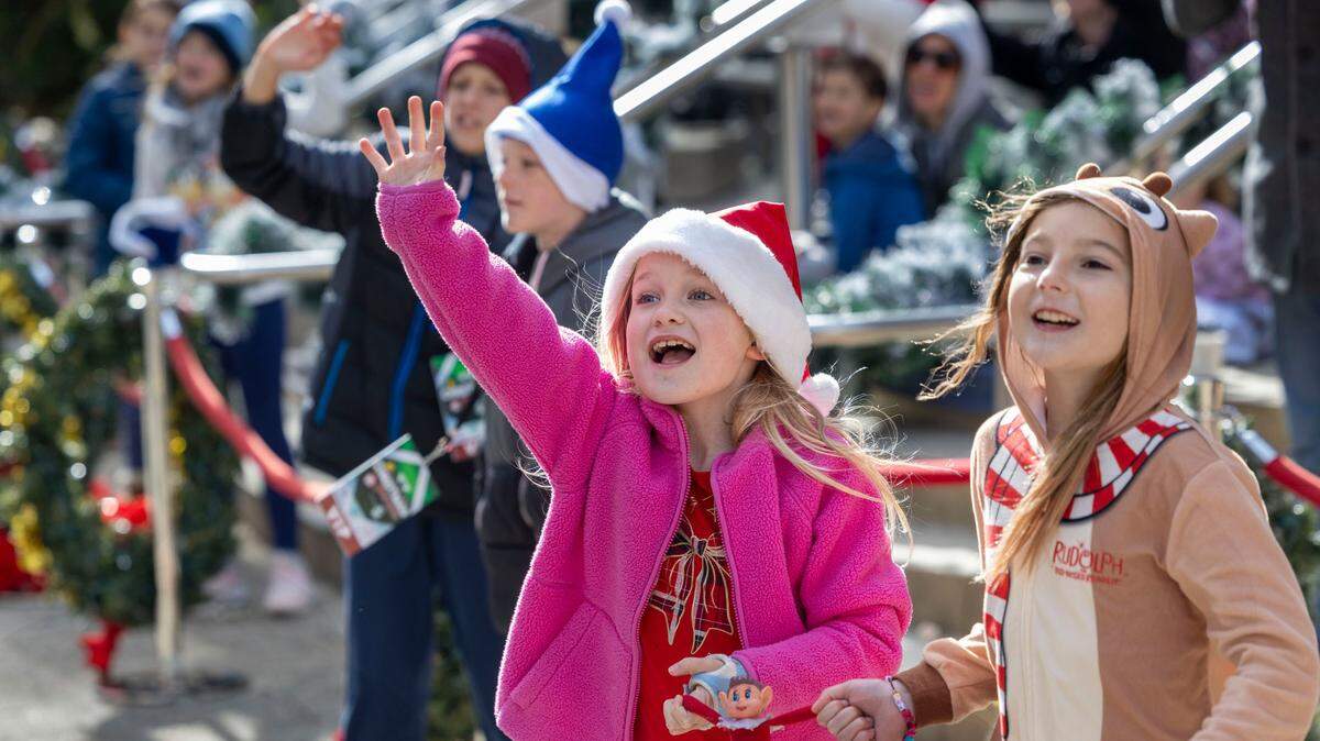 Children along Fayetteville Street greet Santa Claus at the conclusion of the 80th annual Raleigh Christmas Parade on Saturday, November 23, 2024 in Raleigh, N.C.