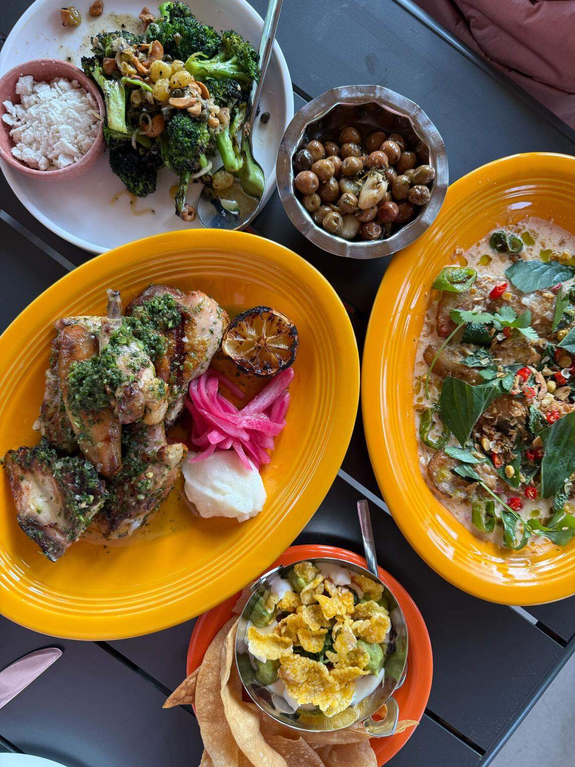 On the opening menu at Big Cat, diners will find crispy grilled broccoli, spicy coconut pork belly, nine layer dip with housemade corn chips and a smoked half chicken.