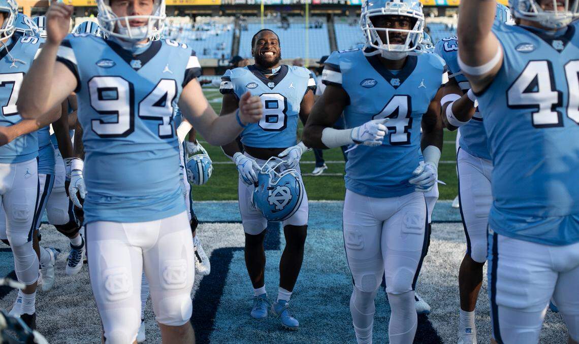 North Carolina’s Michael Carter (8) flashes a big smiles as he leaves the field with his teammates after their 59-53 victory over Wake Forest at Kenan Stadium on Saturday, November 14, 2020 in Chapel Hill, N.C.