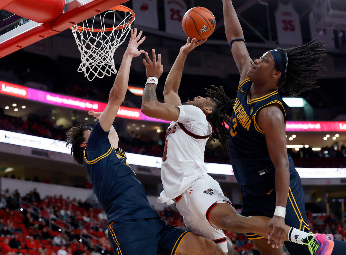N.C. State’s Jayden Taylor shoots over California’s Andrej Stojakovic to tie the score late in the second half of the Wolfpack’s 65-62 loss on Saturday, Jan. 18, 2025, at Lenovo Center in Raleigh, N.C.