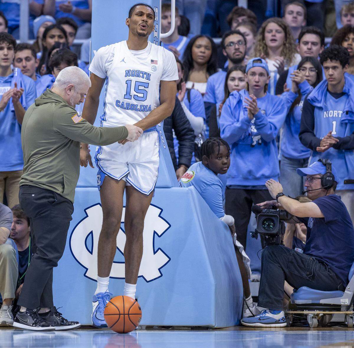 Trainer Doug Halverson helps North Carolina forward Jarin Stevenson (15) to his feet after an injury in the first half against Radford on Tuesday, November 11, 2025 at the Smith Center in Chapel Hill, N.C.
