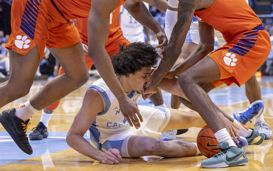 North Carolina forward Zayden High (1) gets a hand in his mouth from Clemson forward Dallas Thomas (8), during a battle for a loose ball, in the first half on Tuesday, March 3, 2026 at the Smith Center in Chapel Hill, N.C.
