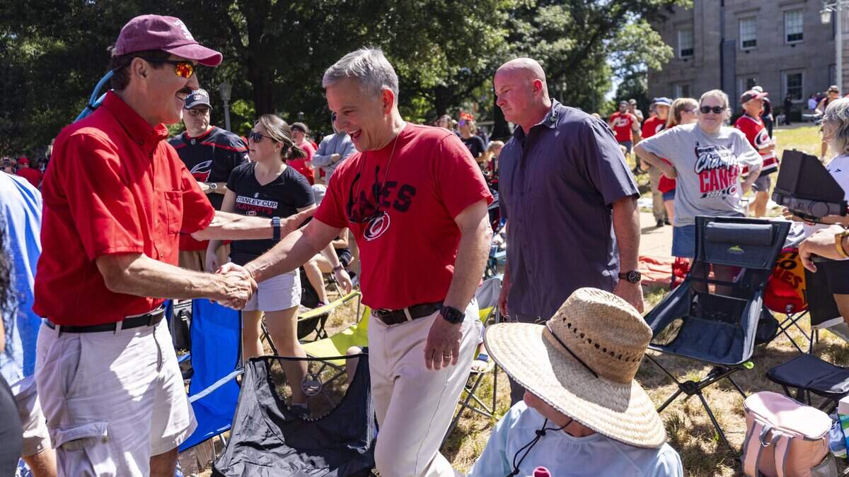 Gov. Josh Stein greets Carolina Hurricanes fans outside the North Carolina State Capitol in Raleigh on Saturday, June 20, 2026, as thousands gathered downtown for a parade and rally celebrating the Hurricanes' Stanley Cup championship. Carolina defeated the Vegas Golden Knights in six games to win the Stanley Cup for the second time in franchise history and the first time since 2006.