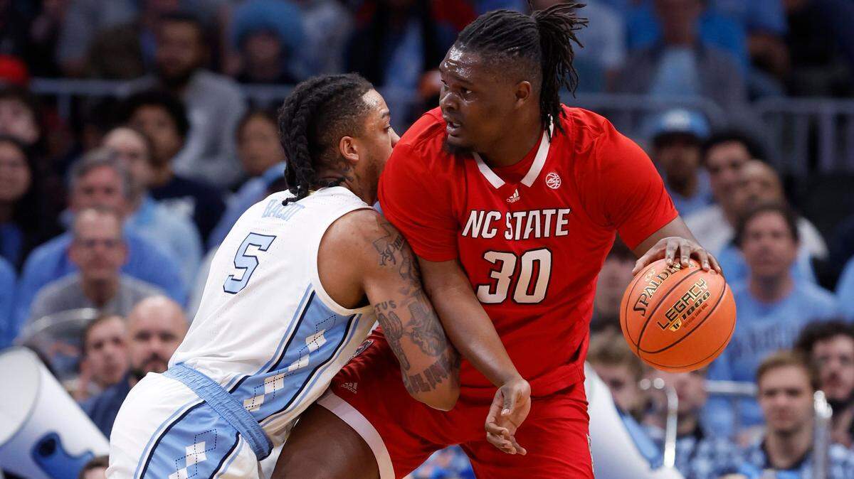 N.C. State’s DJ Burns Jr. (30) works against North Carolina’s Armando Bacot (5) during the first half of N.C. State’s game against UNC in the championship game of the 2024 ACC Men’s Basketball Tournament at Capital One Arena in Washington, D.C., Saturday, March 16, 2024.