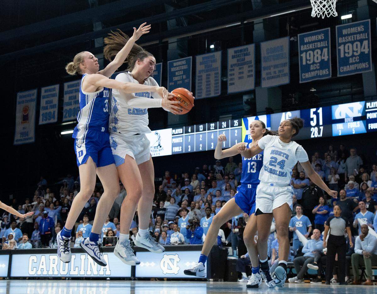 North Carolina’s Blanca Thomas grabs a rebound over Duke’s Toby Fournier during overtime of the Tar Heels’ 53-46 win on Thursday, Jan. 9, 2025, at Carmichael Arena in Chapel Hill, N.C.