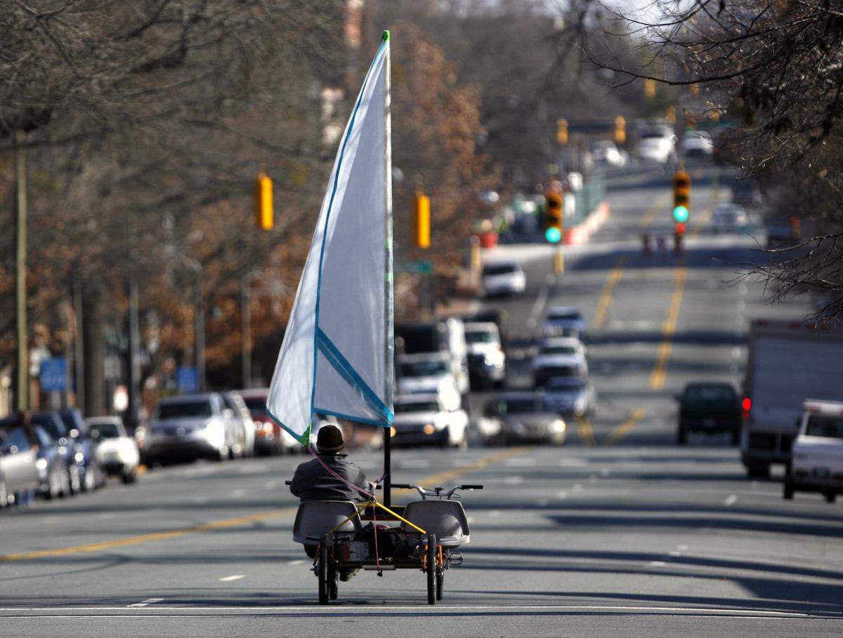 It looked like relatively clear sailing ahead for Carrboro, NC resident Paul Van Ness Thursday, Jan. 5, 2012 as he pedaled and sailed with the help of westerly tail winds on his daily commute down W. Franklin St. to work in Chapel Hill. Van Ness says he hand-built his side-by-side tandem bicycle conveyance, but added his wood and thick plastic twin jib sails for the occasional added power from kindly winds. He often gets stopped on the street fielding questions about his pedal and wind powered transportation.