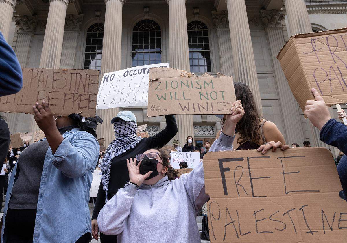Pro-Palestine demonstrators hold signs during a rally in support of Palestinians at UNC-Chapel Hill on Thursday, Oct. 12, 2023. The rally was organized by the UNC chapter of Students for Justice in Palestine.