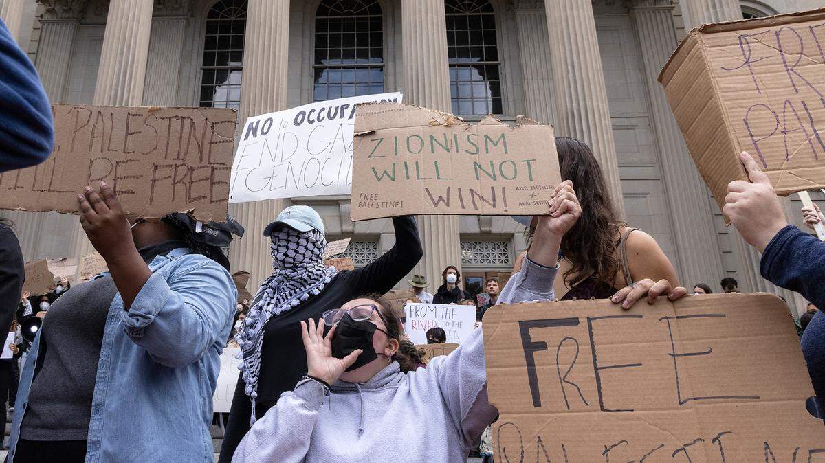 Pro-Palestinian demonstrators hold signs during a rally in support of Palestinians at UNC-Chapel Hill on Thursday, Oct. 12, 2023. The rally was organized by the UNC chapter of Students for Justice in Palestine.