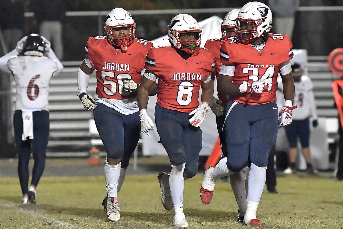Apex Friendship’s Andrew Elko (6) reacts while Jordan linebacker Kamari Blue (8) runs with teammates after making the interception against Elko during the second half.
