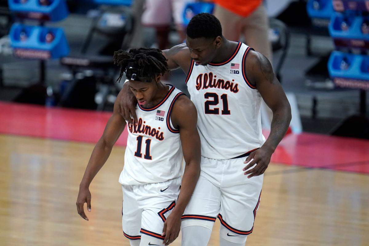Illinois center Kofi Cockburn (21) talks with Illinois guard Ayo Dosunmu (11) after a foul against Loyola Chicagoduring the second half of a men’s college basketball game in the second round of the NCAA tournament at Bankers Life Fieldhouse in Indianapolis, Sunday, March 21, 2021. 