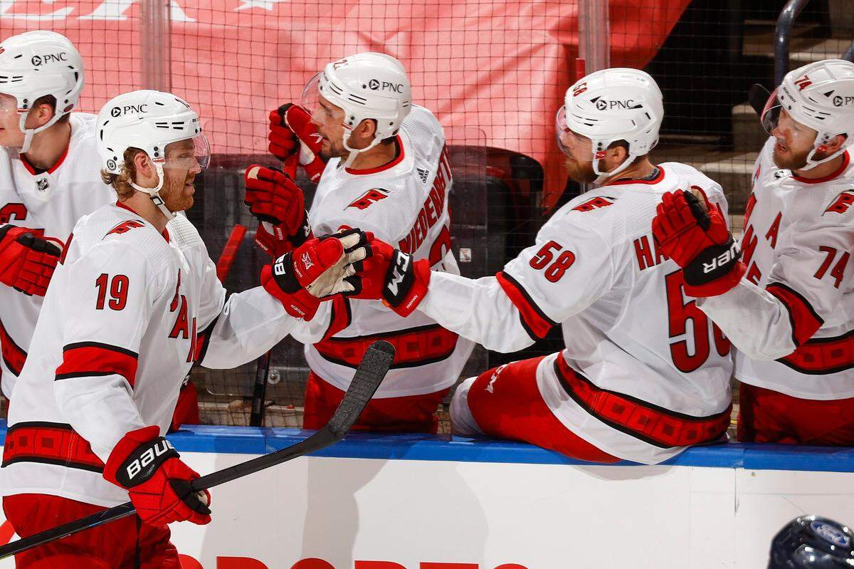 Carolina Hurricanes defenseman Dougie Hamilton (19) is congratulated for his second goal of the night, during the second period of the team’s NHL hockey game against the Florida Panthers, Saturday, April 24, 2021, in Sunrise, Fla. (AP Photo/Joel Auerbach)