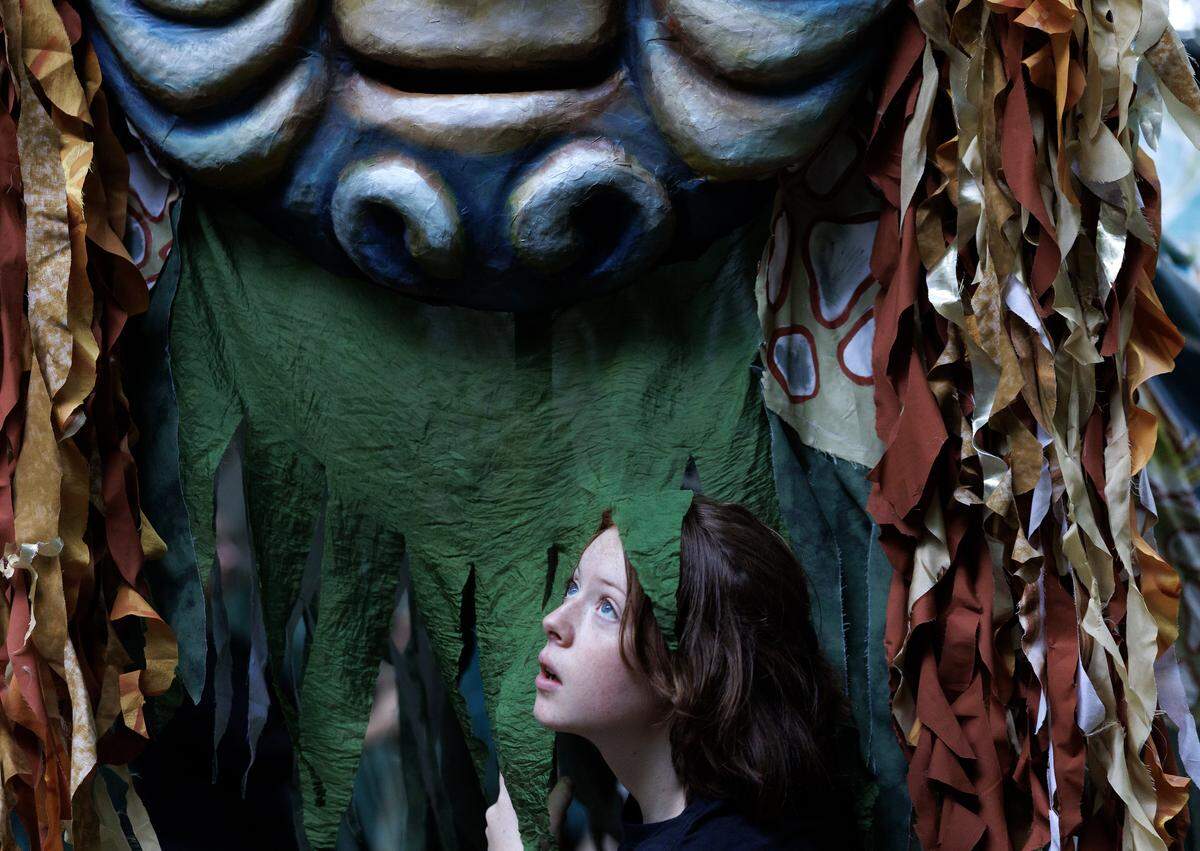 Althea Clayton, a puppeteer with Paperhand Puppet Intervention, looks out from a river puppet during a rehearsal for the organization's show, "The Gift," on Tuesday, Aug. 12, 2025, at the Forest Theatre in Chapel Hill, N.C.