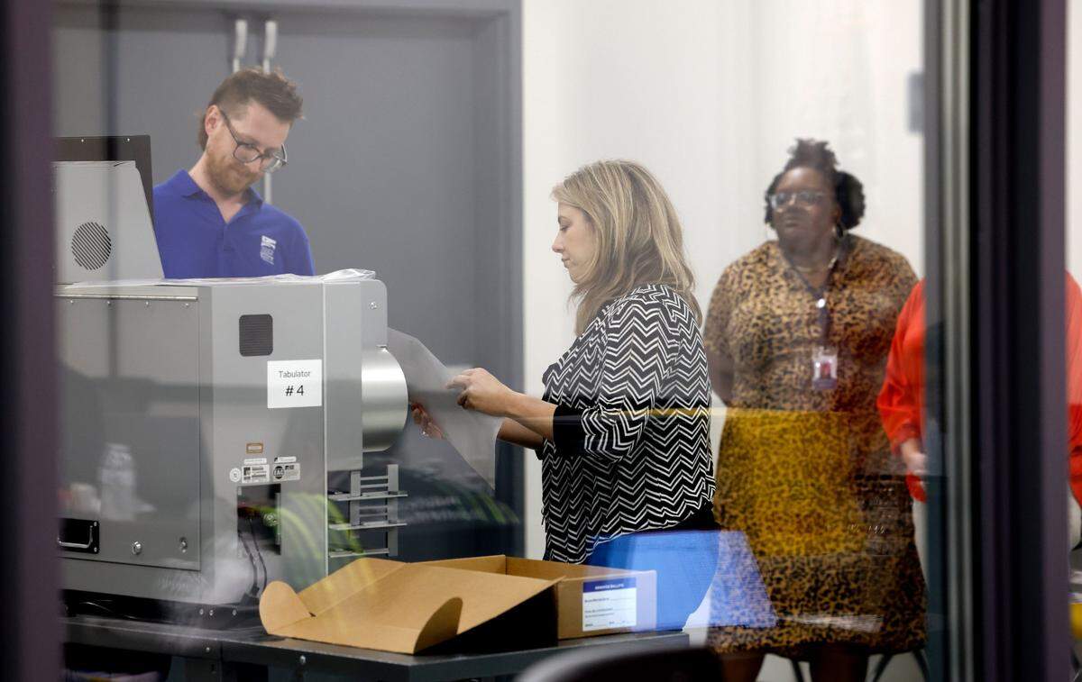 Absentee ballots are scanned during a Wake County Board of Elections board meeting at the operations center in Raleigh, N.C., Tuesday, May 7, 2024.