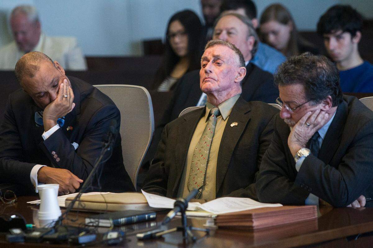 Michael Peterson is flanked by his attorneys James D. “Butch” Williams, left, and David Rudolf, right, Friday, Feb. 24, 2017 at the Durham County Courthouse, in Durham, N.C. Peterson pleaded guilty to manslaughter in an Alford plea for the death of his wife Kathleen Peterson on Dec. 9, 2001.