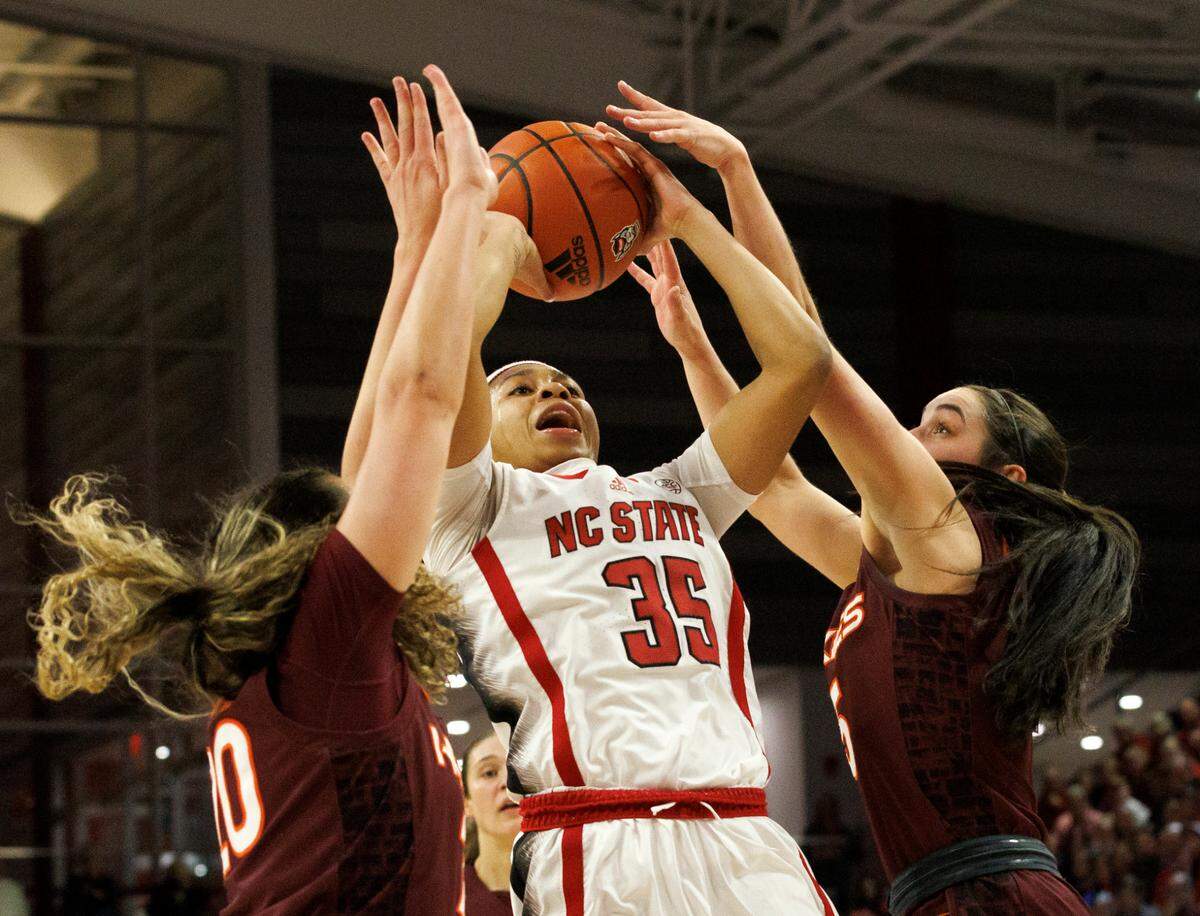 N.C. State’s Zoe Brooks shoots over Virginia Tech’s Olivia Summiel and Georgia Amoore during the first half of the Wolfpack’s 72-61 loss on Thursday, Feb. 8, 2024, at Reynolds Coliseum in Raleigh, N.C.