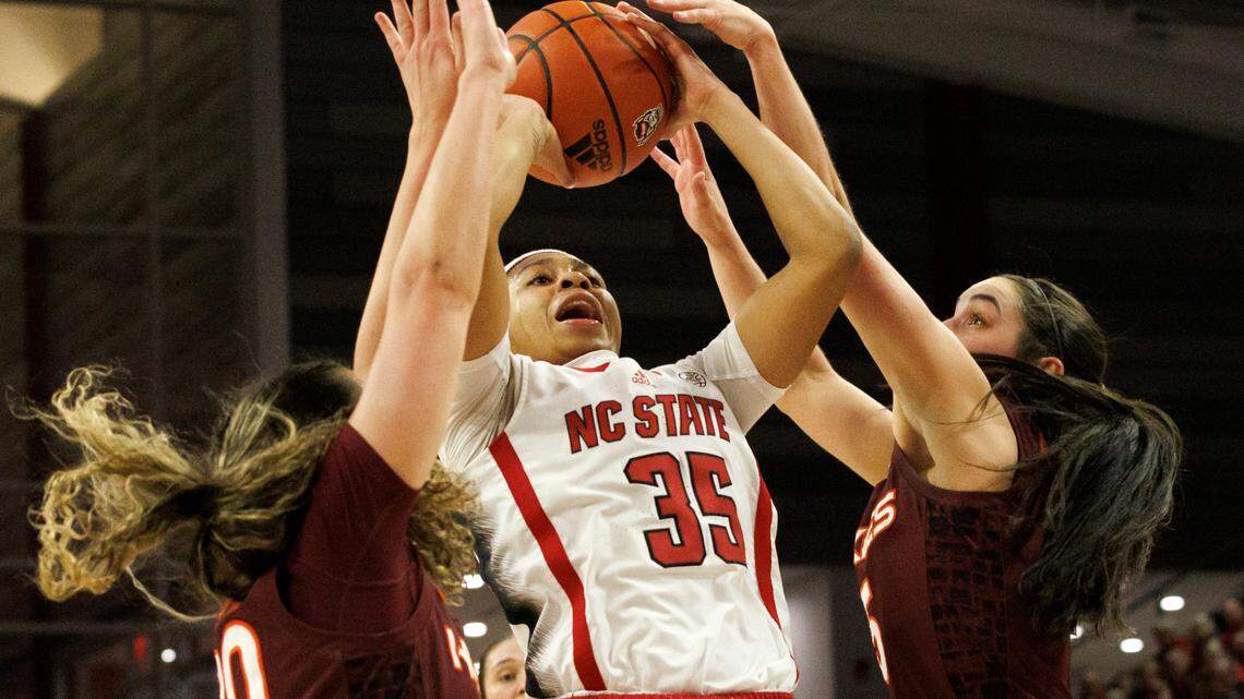 N.C. State’s Zoe Brooks shoots over Virginia Tech’s Olivia Summiel and Georgia Amoore during the first half of the Wolfpack’s 72-61 loss on Thursday, Feb. 8, 2024, at Reynolds Coliseum in Raleigh, N.C.