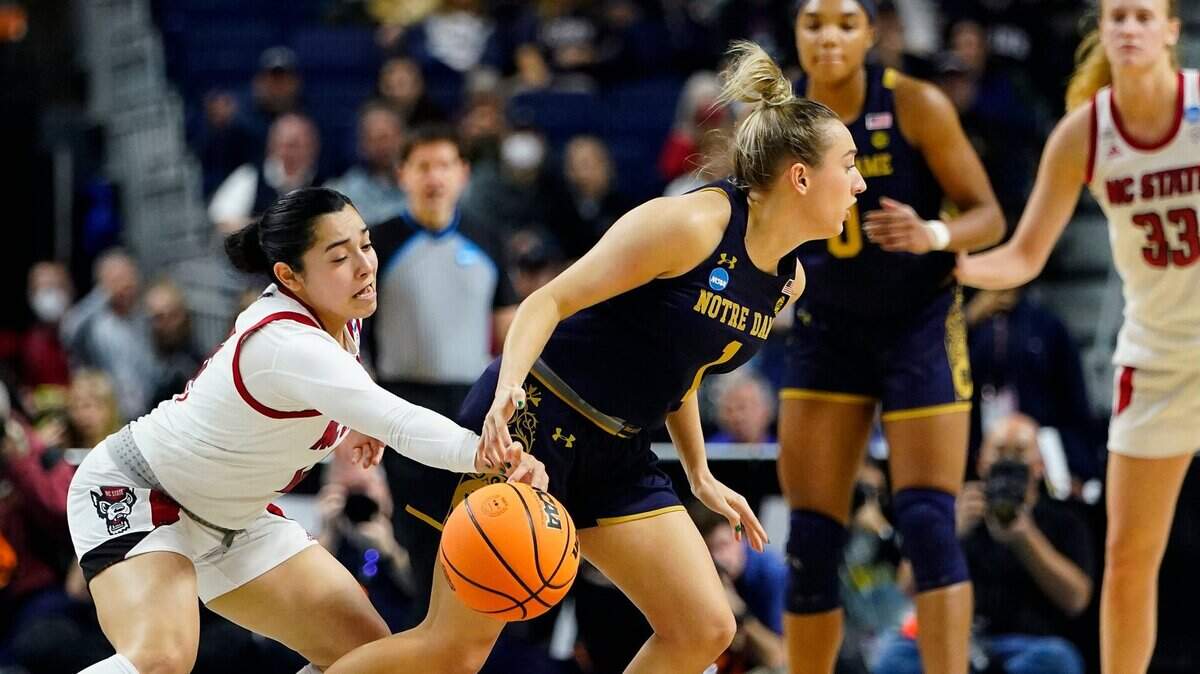 North Carolina State guard Raina Perez (2) strips the ball from Notre Dame guard Dara Mabrey (1) for a steal late in the fourth quarter of a college basketball game in the Sweet Sixteen round of the NCAA women’s tournament.