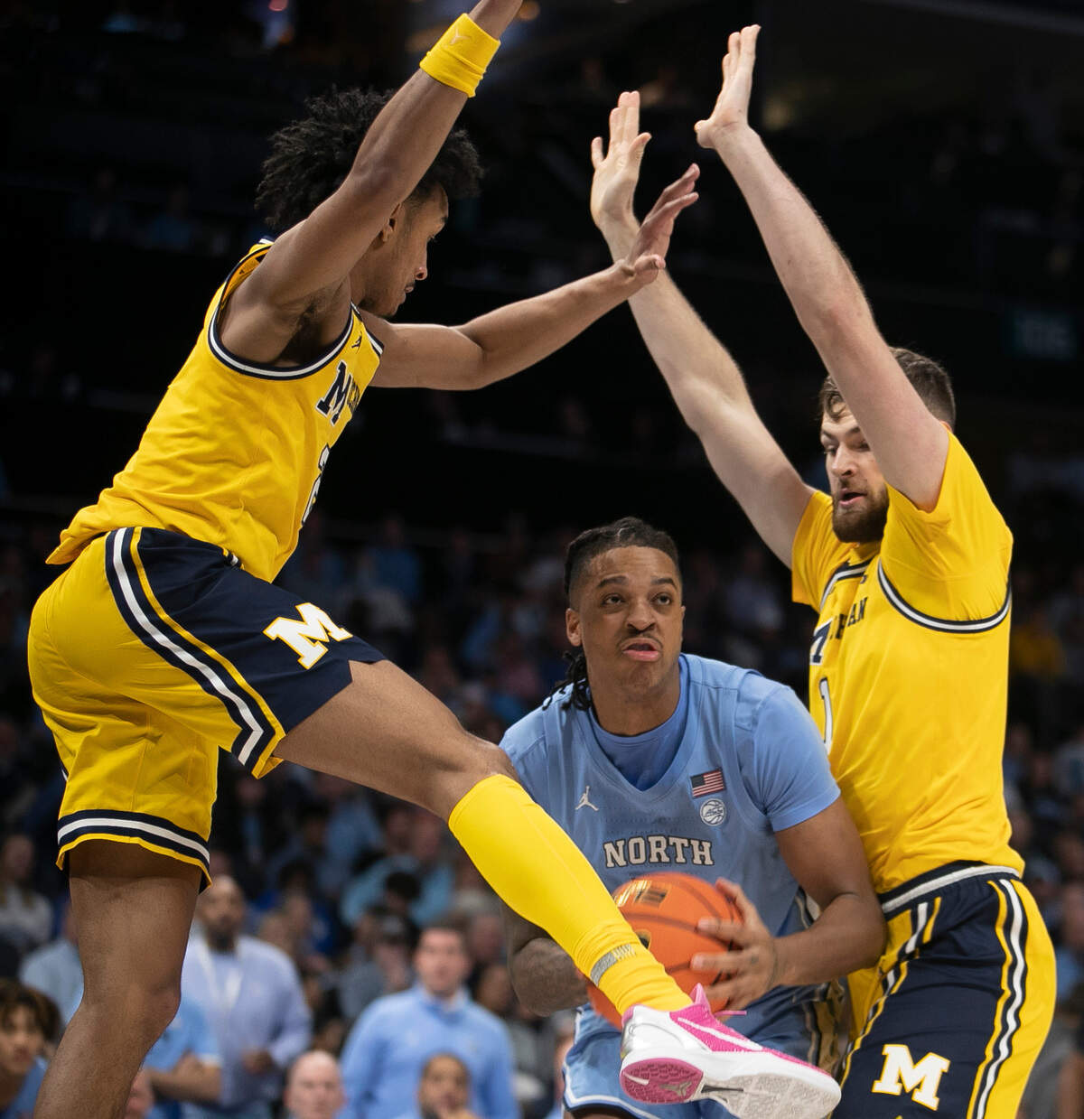 Michigan’s Kobe Bufkin (2) and Hunter Dickinson (1) trap North Carolina’s Armando Bacot (5) in the first half on Wednesday, December 21, 2022 at the Spectrum Center in Charlotte, N.C. Bacot lead all scores with 26 points.