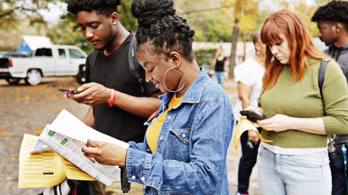 Timbrel Cunningham, center, looks over candidates as a large line forms outside of the Tarboro Road Community Center after Saint Augustine University’s Superior Sound
Marching Band led students to the precinct to vote on Tuesday, Nov. 6, 2018.