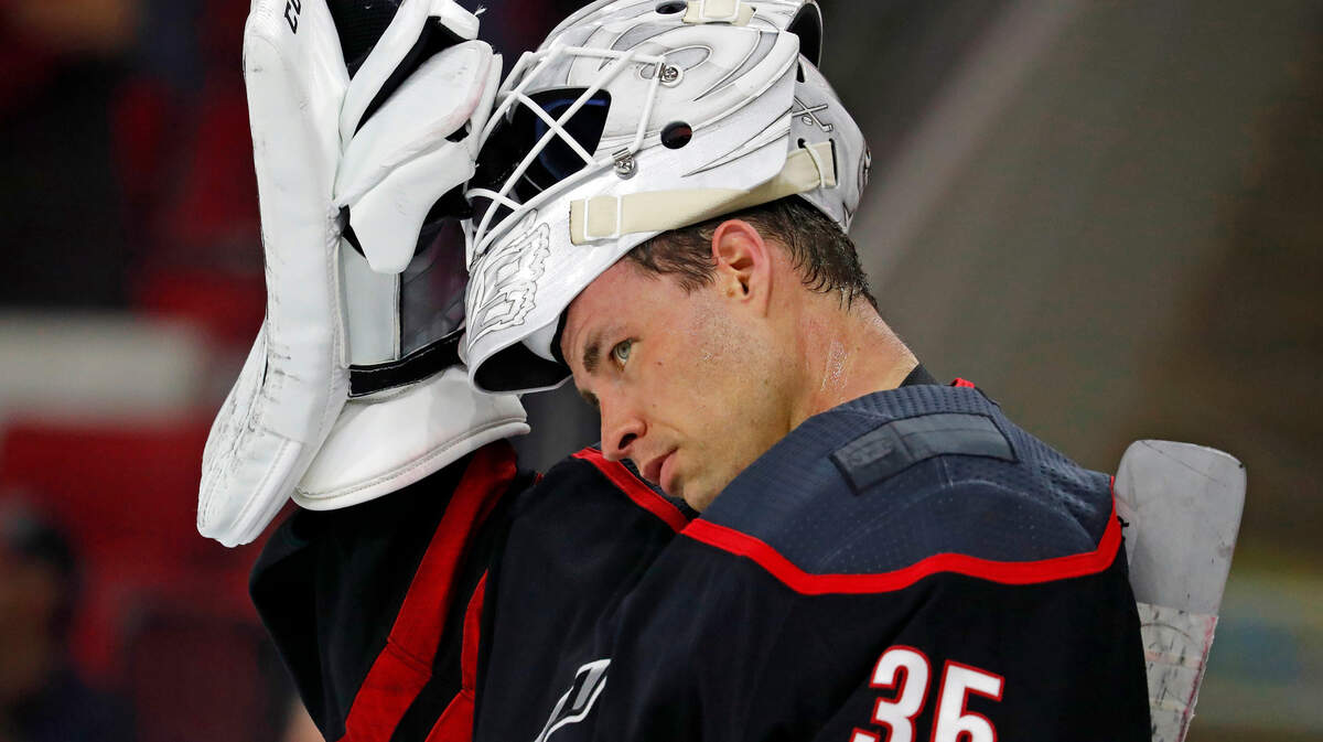 Carolina Hurricanes goaltender Curtis McElhinney (35) takes a break against the Edmonton Oilers during the third period of an NHL hockey game, Friday, Feb. 15, 2019, in Raleigh, N.C.