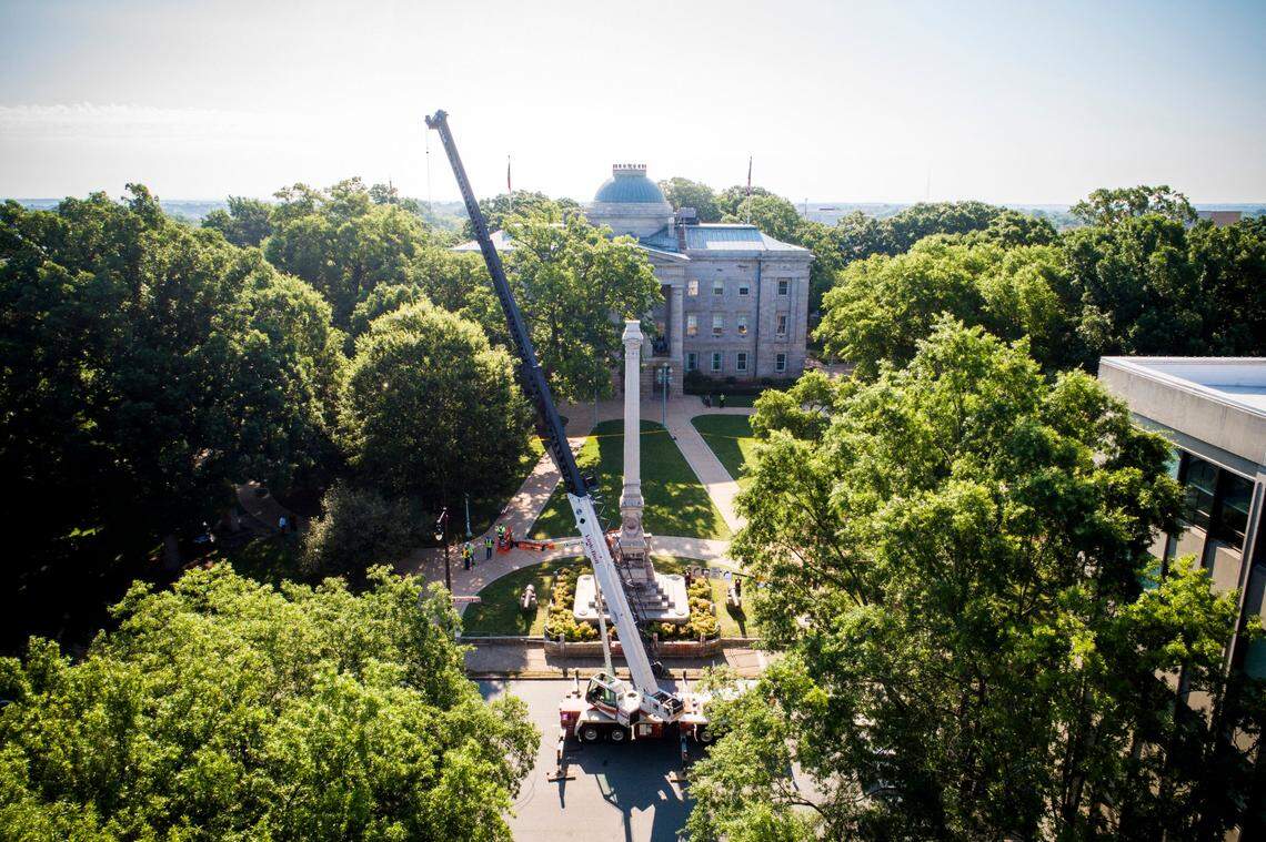 Crews work on removing the North Carolina Confederate monument at the State Capitol in Raleigh, N.C., Sunday, June 21, 2020.