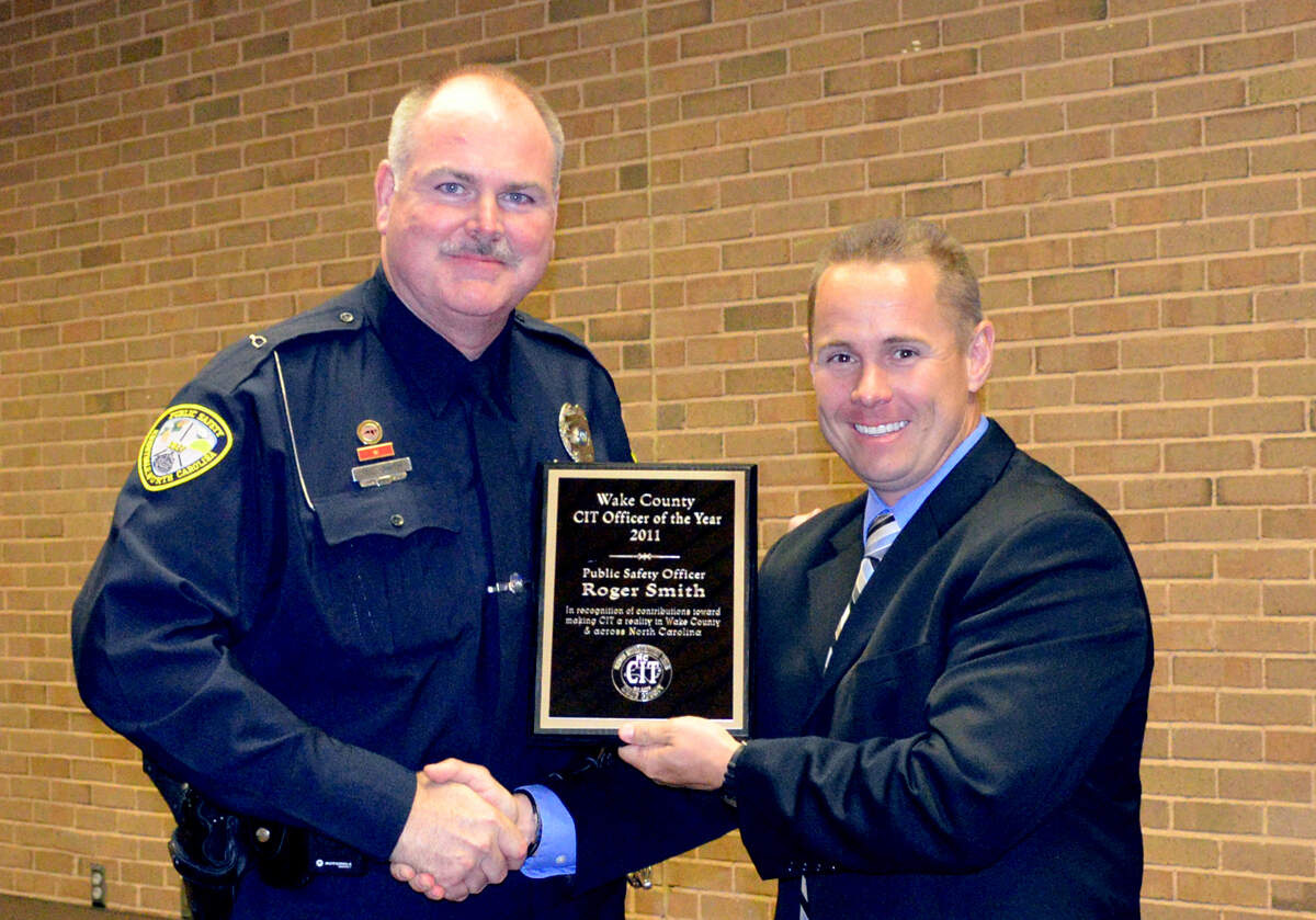 A 2011 photo shows Roger Smith, then a Knightdale police officer, with his chief, Jason Godwin. Smith was one of the 17 Wake County law enforcement Crisis Intervention Team Officers of the Year.